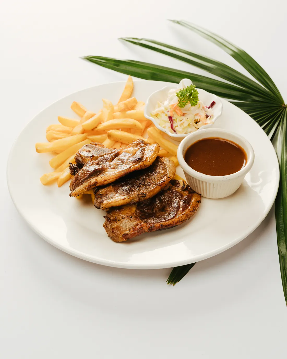 Grilled New Zealand lamb chump with fries, coleslaw and black pepper sauce
