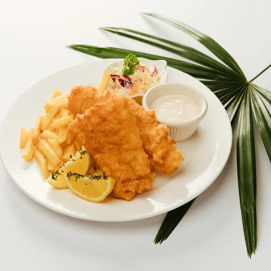 Fish and chips with tartar sauce, coleslaw and lemon