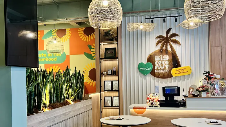Big Coconut Matang — dining room with the palm wall mark and cashier